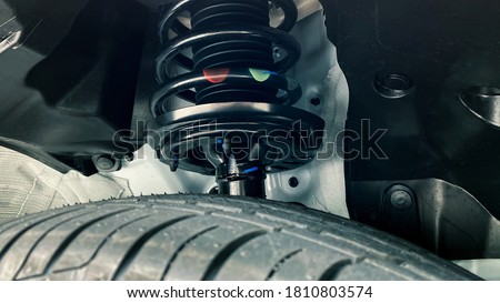 shock absorber strut with coil spring, suspension system of modern car Royalty-Free Stock Photo #1810803574