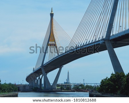 Landscape of cable-strayed bridge across the river. The bridge connect Bangkok and Samut Prakan. Translation of text on the bridge “ King Bhumipol Bridge”.