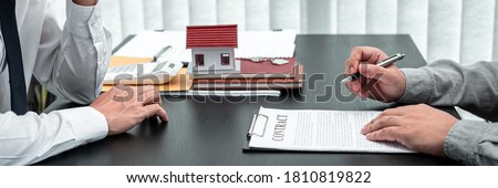 Estate agent are presenting home loan to client and discussing to decision signing agreement contract form, Home Insurance and Real estate investment concept.