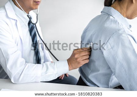 Male doctor checking back of patient and recommend treatment methods and how to use medicine.