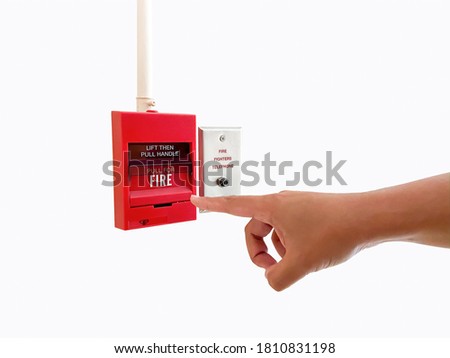 Man finger point at red alarm near fire fighters telephone wire plug isolated on white. Red emergency equipment pull and alert for help protect damage from hot of fire danger in hotel public building