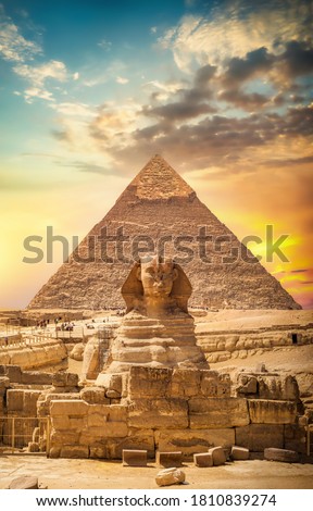 Great sphinx and pyramid under bright sun Royalty-Free Stock Photo #1810839274