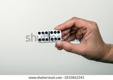 White domino dice with six points. Success, win and chance concept. Woman's hand