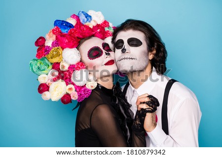 Profile photo of charming creepy romantic couple man lady hold hands meet after lifelong parting wear black dress death costume roses headband suspenders isolated blue color background