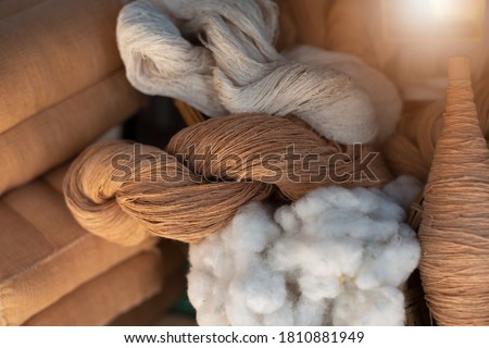 Natural cotton yarn. In rolls. Brown cotton fibers.Natural fibers to protect the environment. Royalty-Free Stock Photo #1810881949