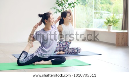 Young asian women doing yoga. Yoga instructor. Royalty-Free Stock Photo #1810905511