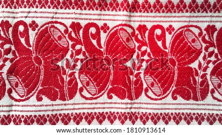 gamosa textile pattern. gamosa or gamusa is an article of significance for the indigenous people of Assam, India. It is generally a white rectangular piece of cloth

