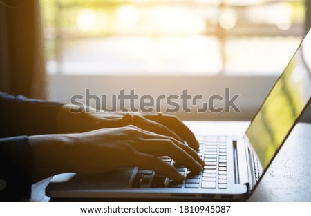 Closeup of hand typing, working on laptop keyboard. Business and working concept.