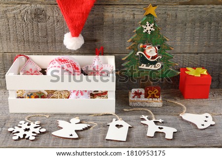 Bright Christmas and New Year decorations made of plywood and fabric is on a gray wooden background. 
