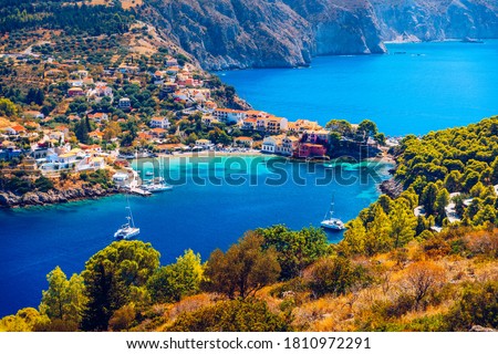 Assos village in Kefalonia, Greece. Turquoise colored bay in Mediterranean sea with beautiful colorful houses in Assos village in Kefalonia, Greece, Ionian island, Cephalonia, Assos village. Royalty-Free Stock Photo #1810972291