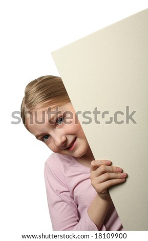 Pretty blond girl peeping over a blank billboard isolated on white