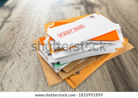 Pile of envelopes with overdue utility bills on the desk Royalty-Free Stock Photo #1810991899