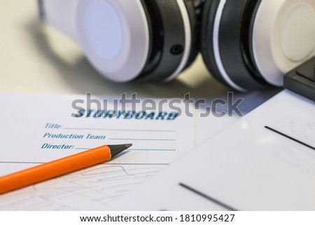 Designer creative drawing in storyboard for film movie, Video Pre-production process in display script production. Design shot scene layout with paper cup coffee and slate in studio.Media product idea
