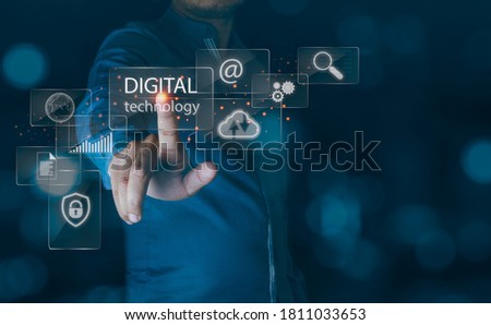 Business and technoloy concept.Business man touch digital technology screen interface and a businessman in background.