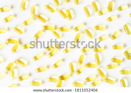 Fish oil capsules on the white background. Sunlight