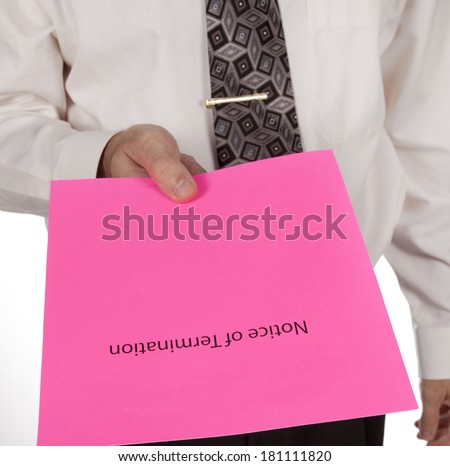 Business man in shirt and tie handing out a notice of termination or pink slip Royalty-Free Stock Photo #181111820