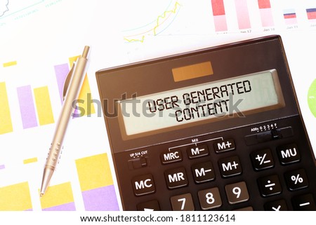 Word USER GENERATED CONTENT on calculator. Business and tax concept