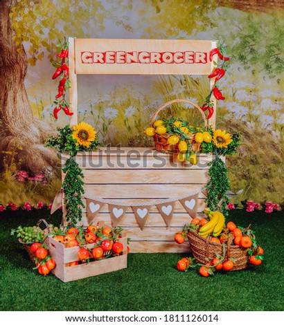 Spring mini photo session in a photo studio with a greengrocers stand