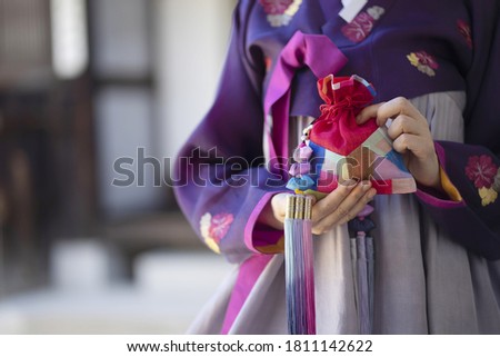 Woman wearing Korean traditional clothes with lucky bag

 Royalty-Free Stock Photo #1811142622