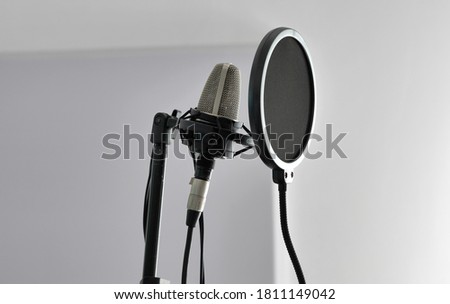 Studio microphone and pop filter for recording audio