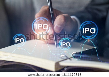 Businessman in suit taking notes. Multiexposure with ipo symbol hologram. Man writing down important information in his business diary. Investment concept.