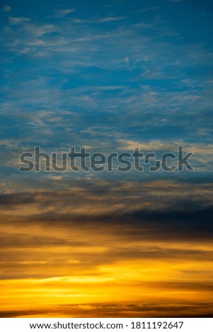 Golden and blue sky with white clouds during sunset, texture and background