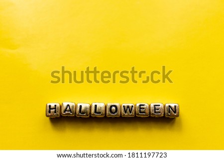 Halloween inscription on the cubes. Halloween title with yellow background.