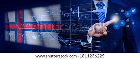 Businessman touching data analytics process system with KPI financial charts, dashboard of stock and marketing on virtual interface. With Faroe Islands flag in background.