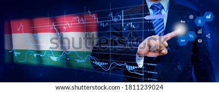 Businessman touching data analytics process system with KPI financial charts, dashboard of stock and marketing on virtual interface. With Hungary flag in background.