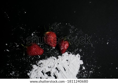 Kitchen table with products, top view. Strawberry and flour. Top view in frame only ingredients.