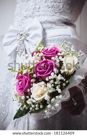 Portrait of a bride with flowers. young beautiful bride holding bouquet. wedding bouquet at bride's hands isolated on white.