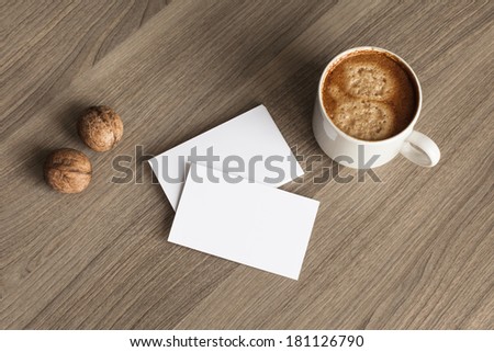 Photo blank a stack of b-cards with cape of coffee and walnuts on a wooden texture
