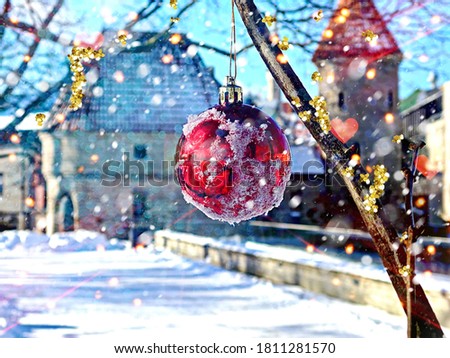 Christmas red ball and snowflakes on tree at city park in medieval old Town of Tallinn holiday winter travel to Estonia 