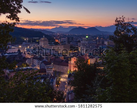 Ljubjana city view form castle hill during sunset with mountains in the background