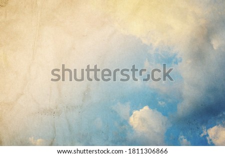 Blue sky with clouds in grunge style with noise.