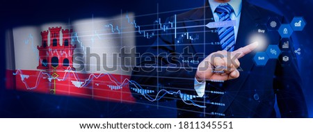 Businessman touching data analytics process system with KPI financial charts, dashboard of stock and marketing on virtual interface. With Gibraltar flag in background.