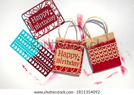 Stamping template with letters of the word happy birthday. Craft with adhesive stencils.