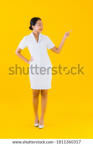 Portrait beautiful young asian woman thai nurse smile happy ready for work for patient in clinic or hospital on yellow isolated background