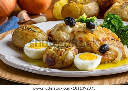 Cod loin baked in olive oil, with potatoes, broccoli, boiled egg and black olives. Typical dish of Portugal.