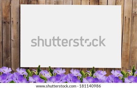 Old wooden brown fence.  Flowers against wooden background. Place for your text.