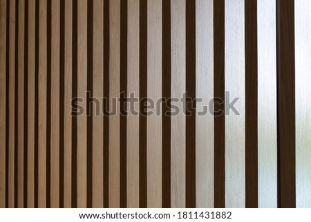 Close up. Seamless pattern of modern wall covering with light brown wooden slats. Background interior design.