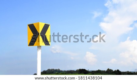 Isolated directional arrow traffic signs with clipping paths on cloudy bluesky background.