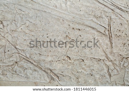 Concrete wall texture with an uneven layer of putty. Textured