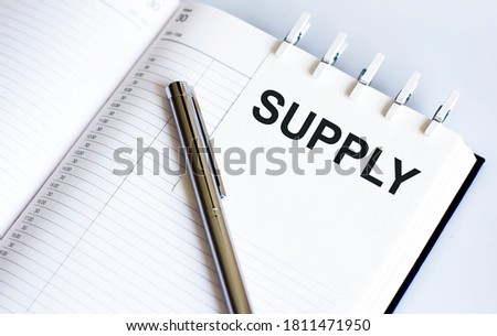 text SUPPLY on short note texture background with pen