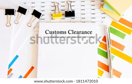 Paper with Customs Clearance on a table with charts