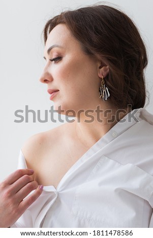 Elegant woman with earrings, close up portrait. Accessories, jewelry and bijouterie concept.
