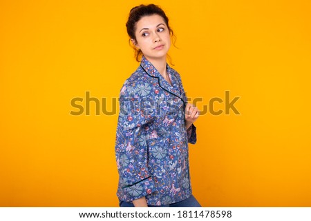 Cute and cheerful woman studio lifestyle yellow background emotions. Copy space.