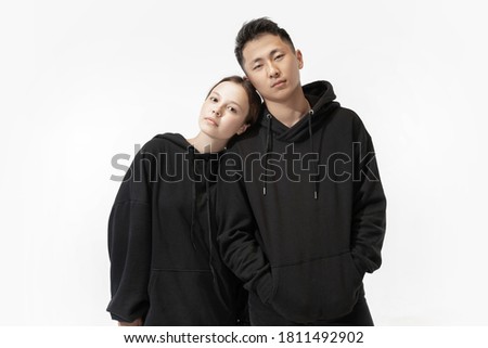 Trendy fashionable couple isolated on white studio background, unisex wear Royalty-Free Stock Photo #1811492902