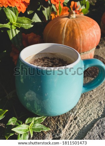 Blue cup of coffee and pumpkin 