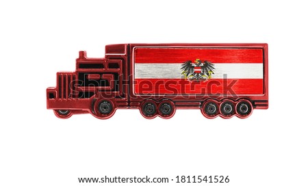 Toy truck with Austria flag shown isolated on white background. The concept of cargo transportation between countries.